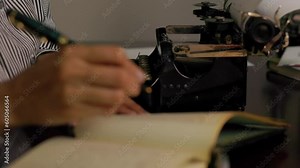 vintage 1910 woman writing in a ledger and typing