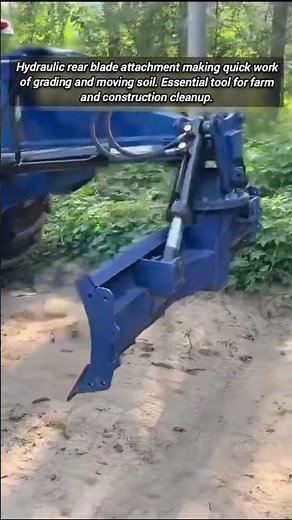 Powerful tractor rear blade grading soil with hydraulic control.