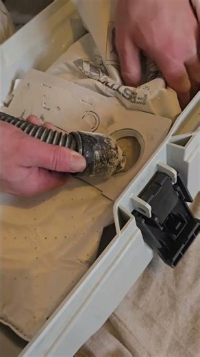 Emptying a Festool bag with a Henry Hoover.