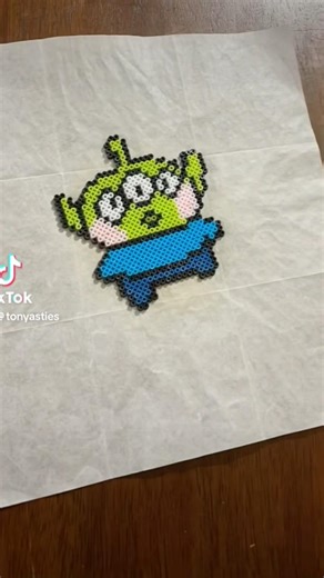 Ironing Toy Story Alien mini Perler art #toystory #pixelart #beadartist #perlerbeadart #alien #claw