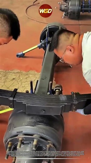 Heavy truck leaf spring installation : Professional mechanic garage maintenance