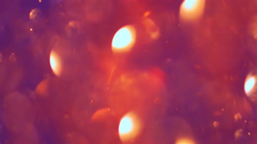 Abstract moving background with circular shapes drifting down and reflecting light over a purple backdrop - Free Stock Video