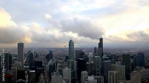 view through window at downtown in chicago with trump tower in background with fast coming cloud and darkening sky wth rain