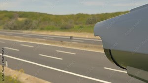 CCTV Camera located along the freeway registers the speed of traffic, and controls road safety. Road traffic safety, surveillance camera. First-person view in close-up, more options in my portfolio