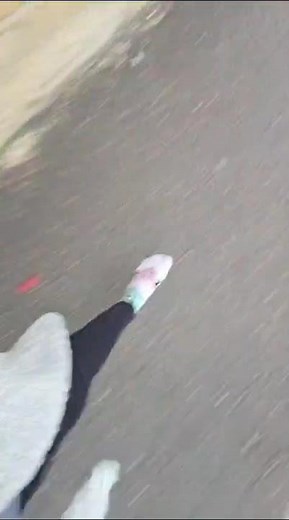 girl walking down street in her socks