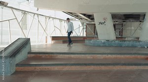 Skater skateboarding skateboarder making 360 flip trick from 4 stairs slow motion kickflip ollie from gap on street bridge.