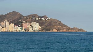 A breathtaking view showcasing a vibrant seaside city adorned with modern architecture and an exquisite shoreline