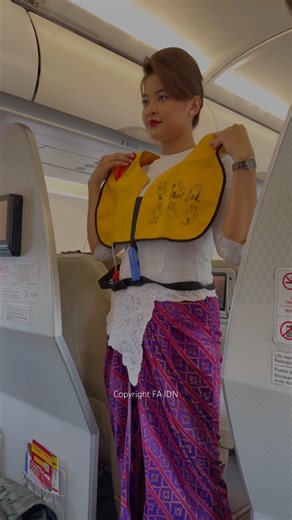 Beautiful flight attendant wearing a life jacket