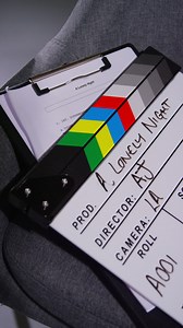Free stock video - Vertical video close up of film clapperboard or slate with production details and script shooting movie or video in studio 2