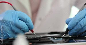 Technician using tool to measure circuit board inspection and repair