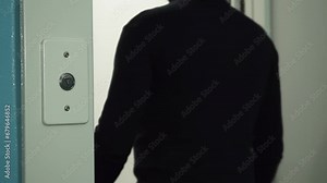 Hand of a man pressing the elevator button. A person enters an elevator in their home, an office center, or a hotel
