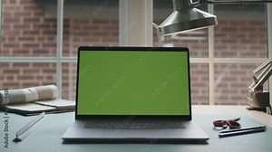Architecture desk work space. Green screen laptop computer sitting on a home work desk. Footage shot with RED, available in 4K and HD. Download the preview for free.