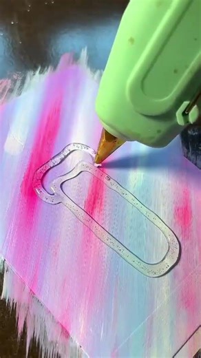 the process of forming wax using glue on a canvas that has been colored