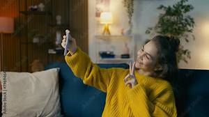 Cheerful teenage girl taking a selfie and texting on phone, social media life