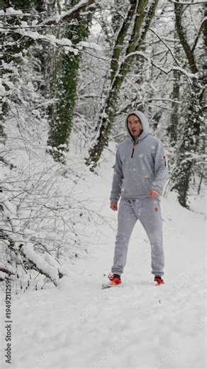 Individual Pauses On Winter Trail For Assessment. Runner In Hoodie Steady After Training During Winter Break. Person Amid Snowline Pauses To Review Breathing And Form During Cold Weather Recovery