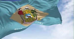 The state flag of Delaware waving in the wind on a clear day....