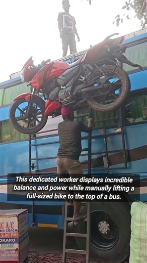 Strong Man Balances Heavy Motorcycle While Climbing Tall Ladder