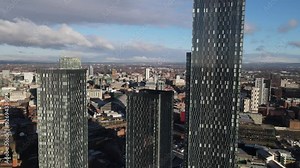 Aeril drone flight over the rooftop of the South Towers ro reveal a view of Manchester City Centre