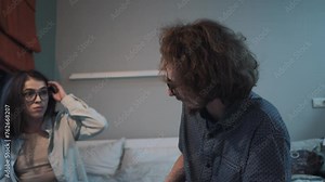 Animated debate between couple, with woman gesturing emphatically during argument.