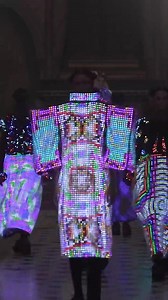 Anrealage's Autumn/Winter 2025-26 Collection as exhibited at Paris Fashion Week. More than mere clothes, Anrealage's (aka Kunihiko Morinaga) imposing graphic black silhouettes are an interface for a new form of fashion, a second-skin screen, envisioning a future where individuals can exchange and share the designs of the clothes they wear. Like a living billboard, soft yarns and textiles embedded with LED-LCD technology - developed in collaboration with MPlusPlus - can be folded, knitted, sewn, 