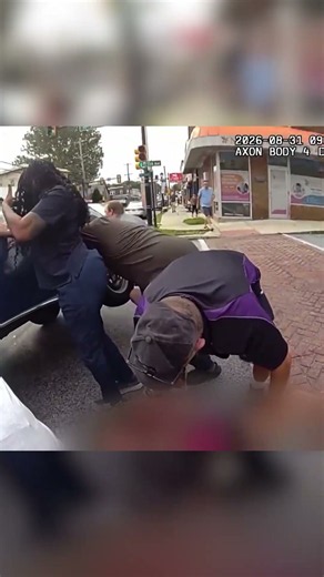 Bystanders pull bicyclist out from underneath a car