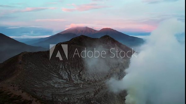 Ijen Volcano sunrise panorama with crater ridge and gas cloud
