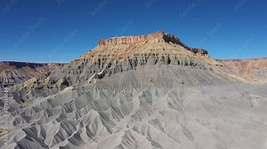Mudstone formations of steel blue wavy sharp rocks ridges western Usa. Factory Butte canyon towering of wonder foothills. Aerial view over rugged terrain dunes structure carved riverbed by erosion