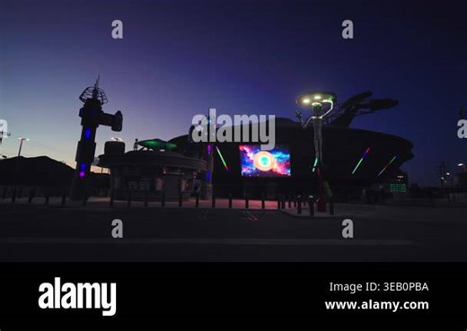 BAKER, California, APRIL 12 2026. Futuristic alien themed roadside attraction with illuminated UFO spacecraft and tall extraterrestrial statue against deep blue twilight sky with colorful neon lights Stock Video Footage - Alamy