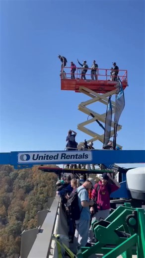 A group of BASE jumpers were participating in Bridge Day 2022 at the New River Gorge Bridge in West Virginia — the only day of the year where BASE jumping is legal from the 876-foot bridge. During a multi-way exit, one jumper deployed his parachute normally, while another delayed his pull and drifted directly above him. Seconds later, the higher jumper lands right on top of the other jumper’s open canopy, collapsing part of the parachute and sending the lower jumper into a violent, uncontrolled 