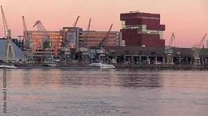 cargo boat passing on Scheldt River at sunset