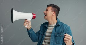 Megaphone, speech and shouting man in studio for broadcast announcement, news or info on grey background. Microphone, noise and frustrated male speaker with message or change, vote or transformation
