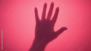 Video of hand of unrecognizable woman abruptly appear, slamming illuminated by pink contour light background and slowly sliding down. Palm hitting rose-colored wall once, reminding scene from horror.