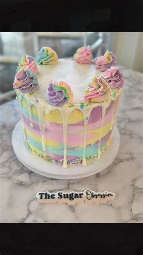 Pretty pastels for a birthday girl! 💕🌈 This strawberry cake is filled with buttercream and frosted in smooth vanilla buttercream, finished with a dreamy pastel palette to match the party theme. Topped with colorful swirls, sprinkles, and a sweet drip, it’s the kind of cake that makes turning 8 feel extra magical. What 8-year-old girl wouldn’t love this cake!? #cake #birthdaycake #pastelcake #cakedrip #fyp