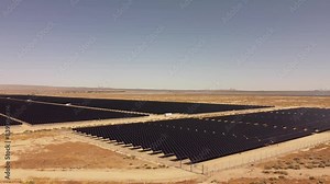 drone captures an aerial view of a solar park in the desert, showcasing photovoltaic cells and modules generating renewable electricity, highlighting green energy technology and sustainability
