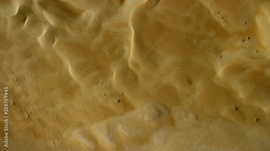 Beautiful sand dunes in the desert Dubai UAE , passing through shoot over angle tilt and change to a full view of the desert dunes and sky horizontal. helicopter, 6-axis, shootover F1, 8K,
