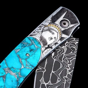 One of William Henry's most exclusive knives: the ‘American Liberty’, featuring bolsters with 24K gold, hand-engraved by Giorgia Contessa. The handle is made from 'Zinc Matrix' turquoise from the ancient Indian mine in Kingman, Arizona. The blade is hand-forged 'Intrepid' damascus, hand-forged by mastersmith Chad Nichols; the one-hand button lock and the thumb stud are set with diamonds. Limited Edition of 10 pieces only. | William Henry