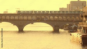 Train of Parisian subway (line 6) passing on Pont de Bercy over river Seine in Paris, France