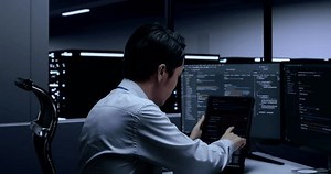 clip-1099790005-close-side-view-asian-male-programmer-looking