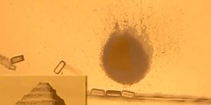 Computer-Controlled Swarm of Bacteria Builds Tiny Pyramid