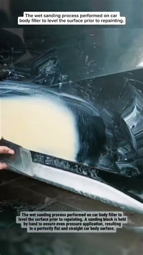 The wet sanding process performed on car body filler to level the surface prior to repainting