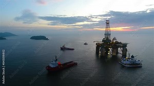 Aerial view from a drone of an offshore jack up rig at the offshore location during daytime. Oil rig drilling platform in the sea.