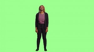 Cheerful model laughing with full body over greenscreen backdrop, having fun and acting positive in studio. Woman smiling and feeling joyful, standing on green screen background.