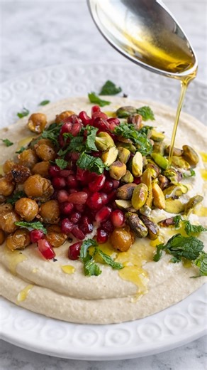 Looking 👀 for the recipe, it’s here ⬇️ I think I have tried every method to make creamy hummus, I’ve soaked dried chickpeas overnight, cooked them with baking soda, scrubbed off the skins and none of those methods compare to the taste and easiness of this recipe. I hope you try this one 🌱The Creamiest Hummus🌱 8 ounces tahini Juice from 1 large lemon 1/4 to 1/2 cup water 1 box chickpeas, drained ( reserve about a tablespoon of chickpeas) 1 clove garlic 1 teaspoon Himalayan pink salt Cold water