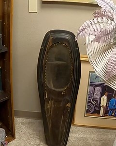 We’re checking out some of the coolest funeral antiques including scaled-down “salesman samples” of caskets and burial vaults that door to door reps used to sell families on features. You can see how the models show the full setup: the vault outside, the casket inside, and even an extra metal layer wooden door for added protection before burial. Then things get even more intense when we spot a real child sized glass face casket (not a sample), showing the stark difference between display pieces 