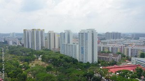 Aerial 4k footage of Public Housing Apartments of Singapore with Singapore skyline In Front Of A Nature Park In Singapore