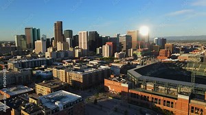 downtown cityscape of buildings in Denver Colorado with Coors field and new urban living gentrified apartments and condominiums