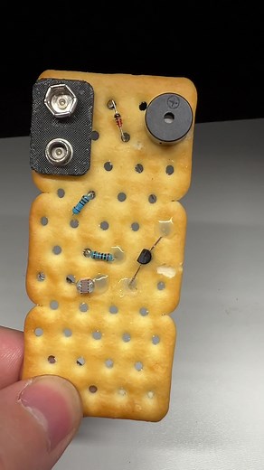 Did you know you can build an electronic circuit even on a cracker?🤯 In this experiment I created a laser door alarm using a snack instead of a traditional circuit board. I inserted into the cracker holes: 🔋 a battery 🔔 a buzzer 🌗 a light sensor 🔧 a few resistors When the laser hits the sensor, the circuit stays silent. But if someone opens the door and breaks the beam, the alarm immediately goes off! 🚨 A fun way to show that electronics can work on almost any surface. #electronics #diypro