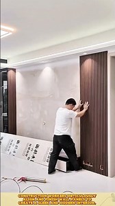 Wall finishing work: Construction worker align, secure, and perfect modern interior panels