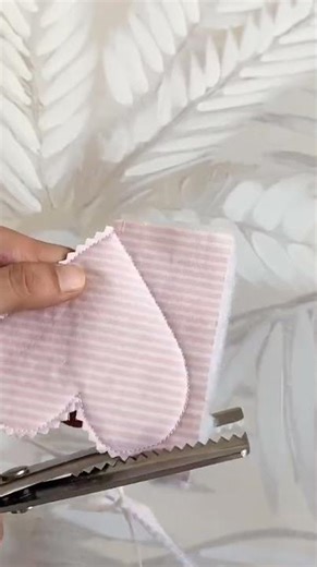 the process of cutting fabric with serrated scissors to form a heart