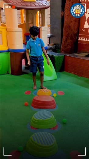 Podar Prep Gandhidham on Instagram: "Through simple movement based activities like ball collecting on a balancing beam, children strengthen balance, coordination, and focus in a playful way. Each step helps them become more confident in their movements while enjoying the process of learning through action. [Physical Development, Motor Skills, Balance and Coordination, Experiential Learning, Podar Prep]"